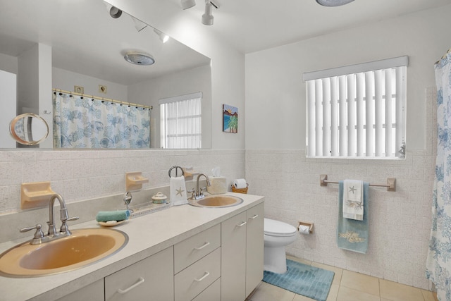 bathroom featuring vanity, tile walls, tile patterned floors, and toilet