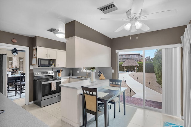 kitchen with sink, ceiling fan, appliances with stainless steel finishes, white cabinets, and kitchen peninsula