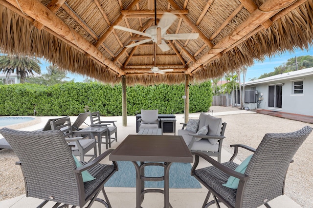 view of patio / terrace featuring a gazebo, ceiling fan, and an outdoor living space