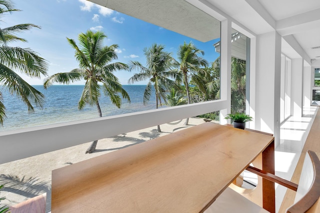 interior space featuring a water view and a view of the beach