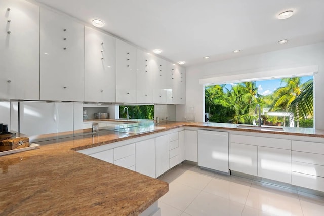 kitchen with light tile patterned flooring, electric cooktop, white cabinetry, sink, and white dishwasher