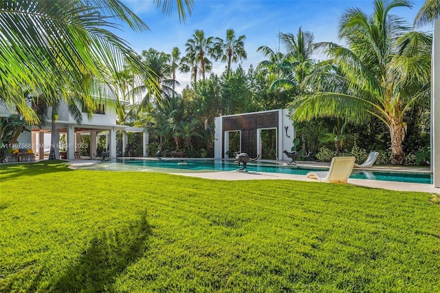 outdoor pool with a patio area, an outdoor structure, and a yard