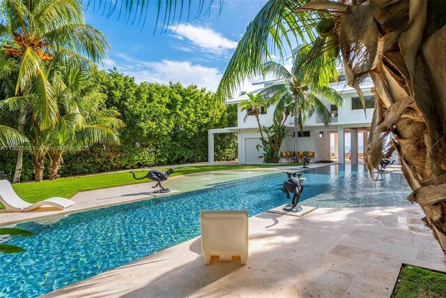 view of play area with a pool and a patio