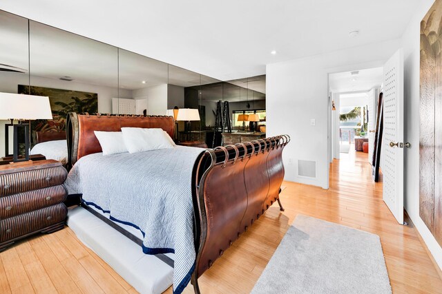 bedroom featuring visible vents and light wood-style flooring