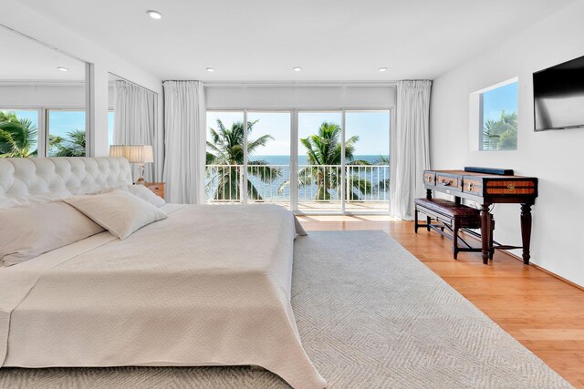 bedroom featuring access to outside, recessed lighting, and light wood-style floors