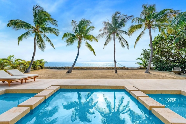 view of swimming pool featuring a patio and a pool with connected hot tub