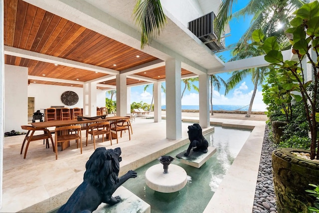 view of patio featuring outdoor dining area and cooling unit