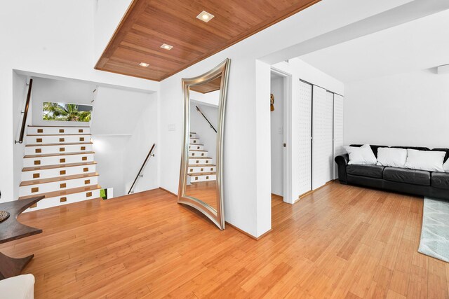 interior space with wooden ceiling, light wood-type flooring, and stairs