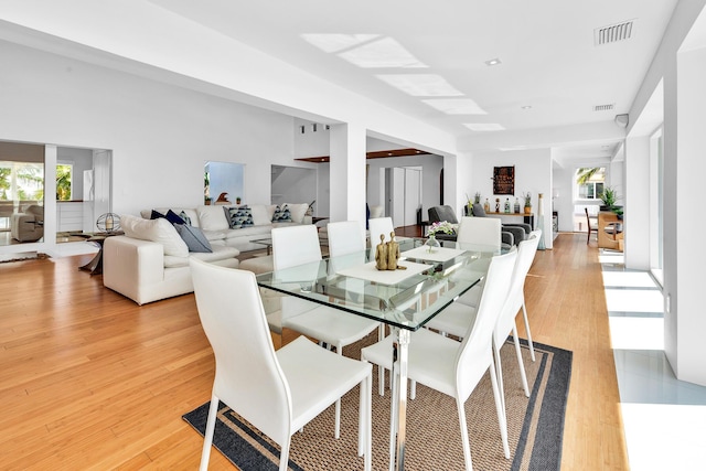 dining room featuring plenty of natural light, visible vents, and light wood finished floors