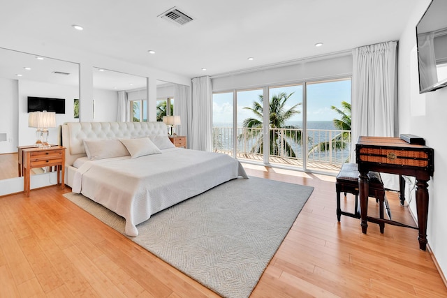 bedroom with recessed lighting, visible vents, access to exterior, and light wood finished floors