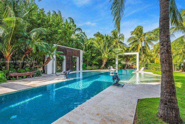 pool featuring an exterior structure, an outbuilding, and a patio area