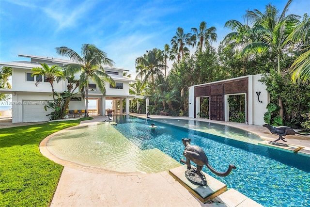 pool featuring a storage structure, a yard, a patio, and an outbuilding