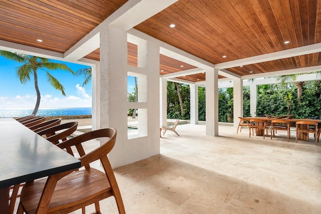 sunroom / solarium with a wealth of natural light, wooden ceiling, and a water view