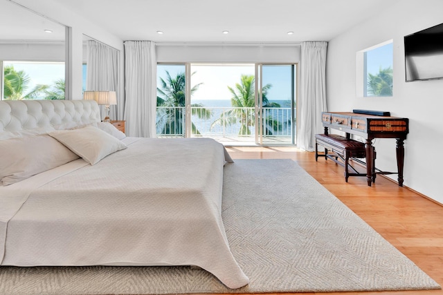 bedroom featuring access to exterior and hardwood / wood-style floors