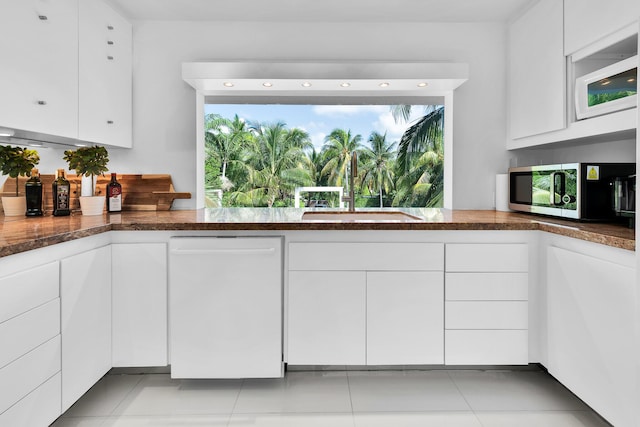 kitchen featuring white cabinetry, white appliances, dark stone counters, and sink