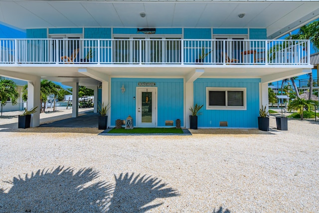 view of front facade with a carport and a balcony