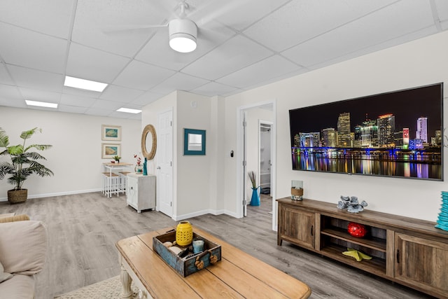 living room with hardwood / wood-style floors and a drop ceiling