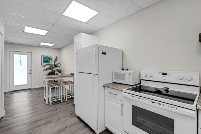 kitchen with white cabinetry, white appliances, a paneled ceiling, and light wood-type flooring