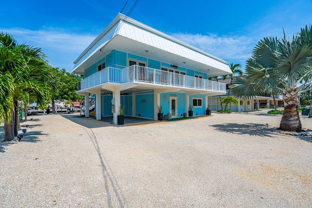 exterior space with a carport and a balcony