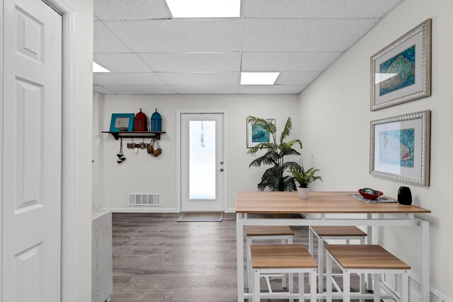 entryway featuring hardwood / wood-style flooring and a paneled ceiling