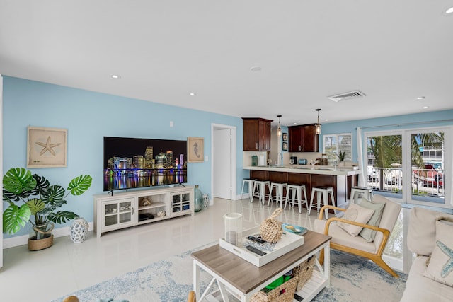 living room with sink and light tile patterned floors