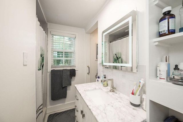 bathroom with tasteful backsplash and vanity