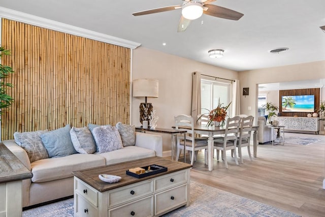 living room with ceiling fan and light hardwood / wood-style floors