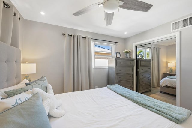 bedroom with ceiling fan, hardwood / wood-style floors, and a closet