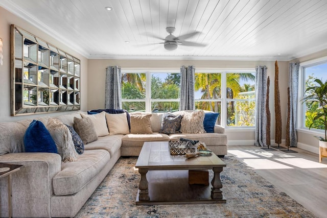 living room with crown molding, wood ceiling, and a healthy amount of sunlight