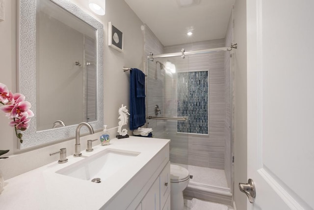 bathroom with vanity, an enclosed shower, and toilet