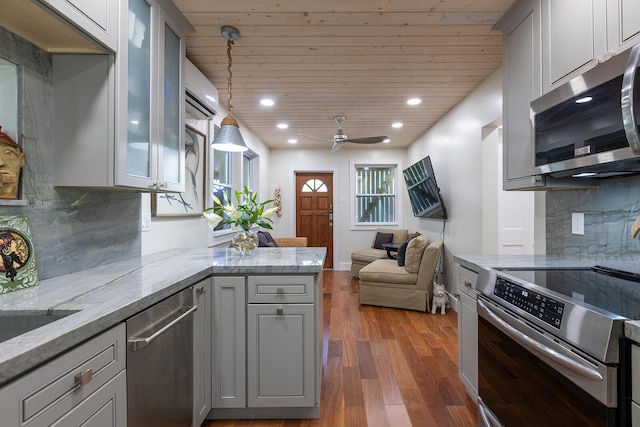 kitchen featuring pendant lighting, appliances with stainless steel finishes, and gray cabinets