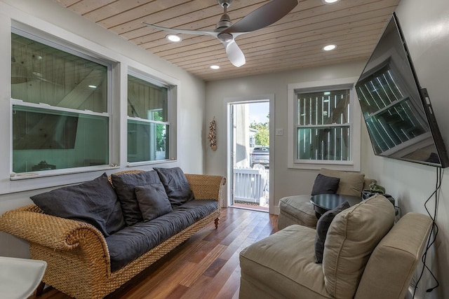 living room featuring dark hardwood / wood-style floors, wooden ceiling, and ceiling fan