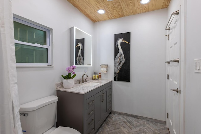 bathroom with parquet floors, wood ceiling, vanity, and toilet