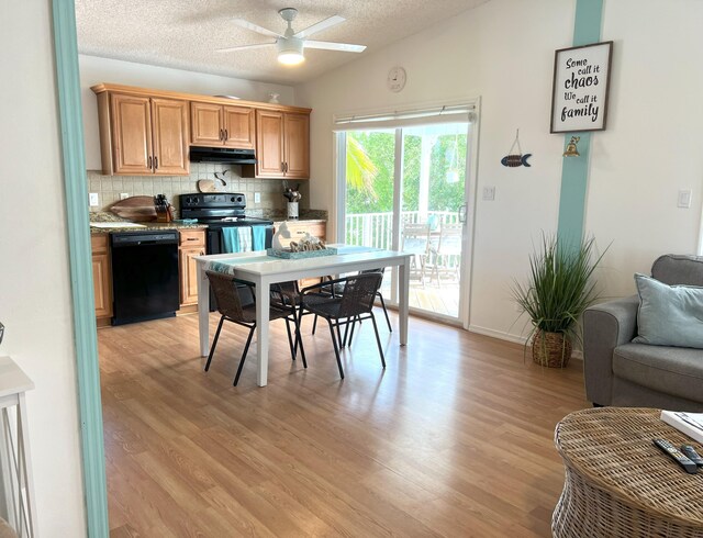 kitchen featuring tasteful backsplash, vaulted ceiling, a textured ceiling, light hardwood / wood-style floors, and black appliances