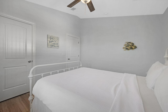 bedroom featuring ceiling fan, lofted ceiling, and light hardwood / wood-style flooring