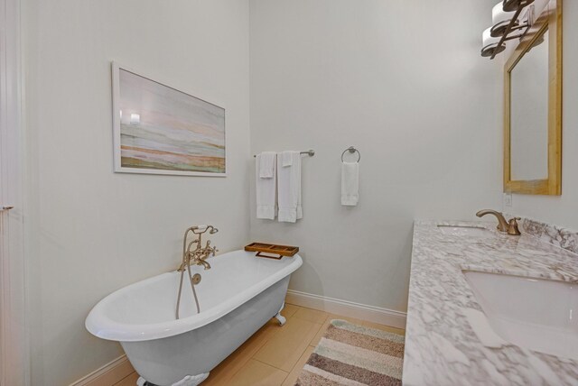 bathroom with tile patterned floors, vanity, and a bathing tub