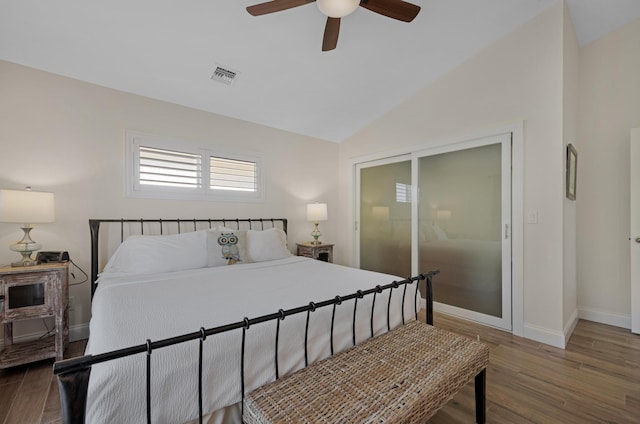 bedroom with dark wood-type flooring, ceiling fan, and lofted ceiling