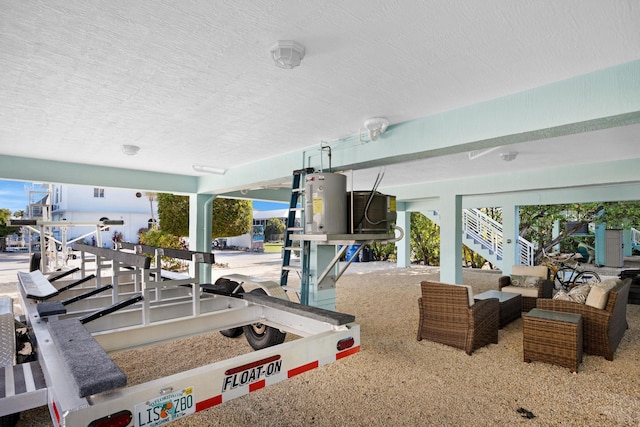 workout area featuring water heater and a textured ceiling