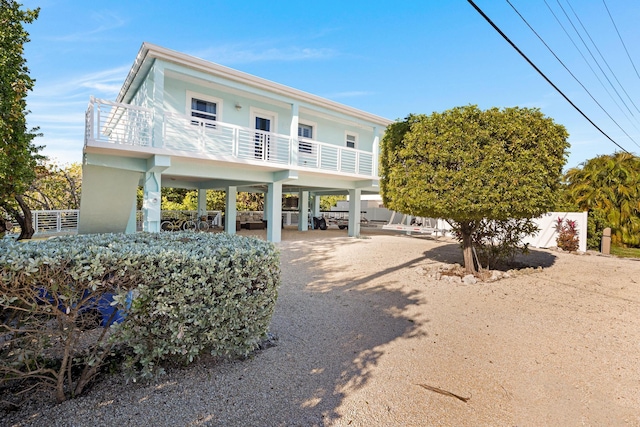 view of front of house featuring a carport and a balcony