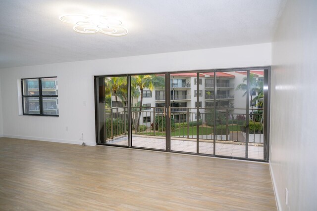 empty room with light hardwood / wood-style flooring