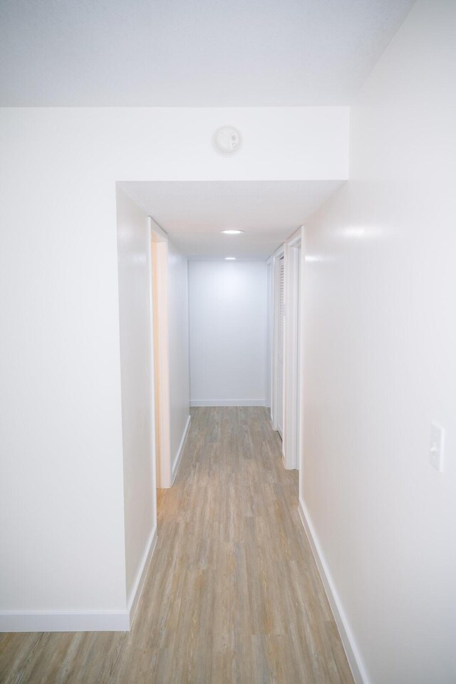 hall with light hardwood / wood-style flooring