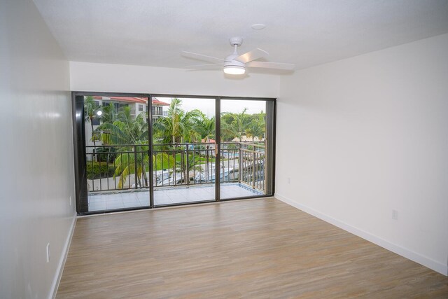 empty room featuring ceiling fan and light wood-type flooring