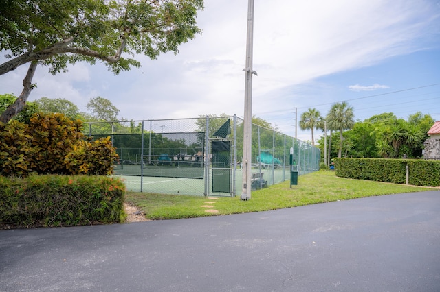 view of sport court featuring a lawn