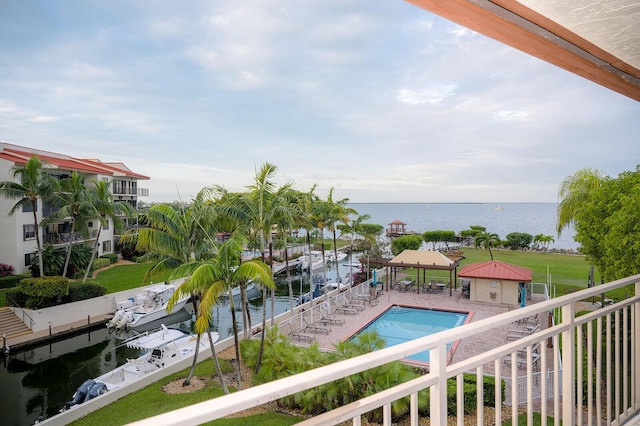 view of pool with a water view, a gazebo, and a boat dock