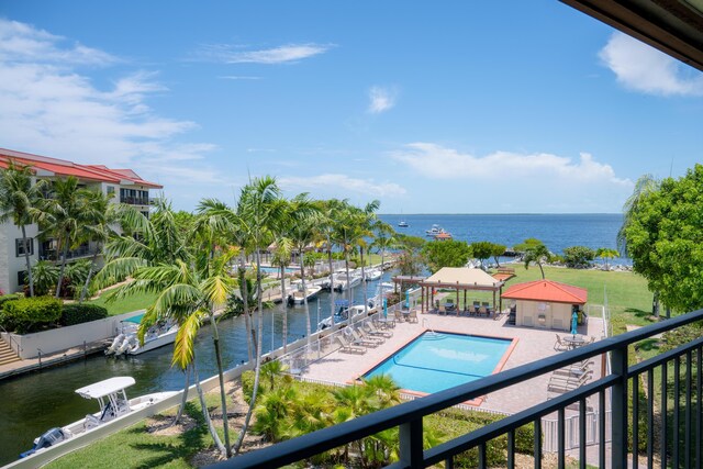 view of swimming pool with a water view and a gazebo