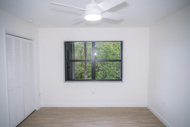 unfurnished bedroom with a closet, ceiling fan, and light hardwood / wood-style flooring