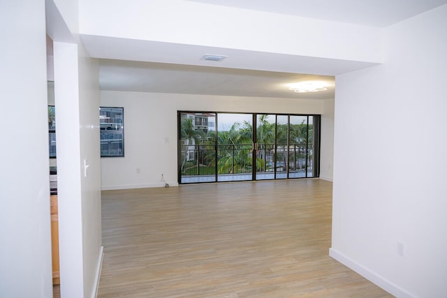 unfurnished room featuring light hardwood / wood-style floors