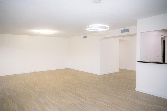 spare room with wood-type flooring