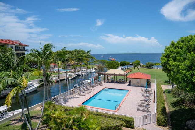 view of swimming pool with a gazebo, a water view, and a patio area