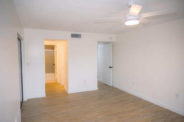 unfurnished room featuring ceiling fan and light wood-type flooring